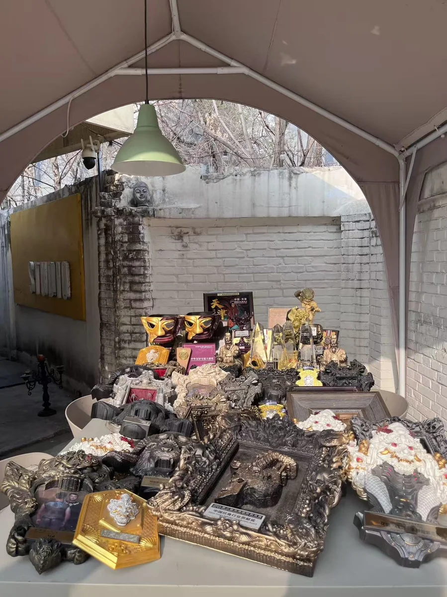 Lei Shi Tattoo studio awards display — international tattoo convention trophies and championship wins under the iconic arched entrance of the Beijing studio