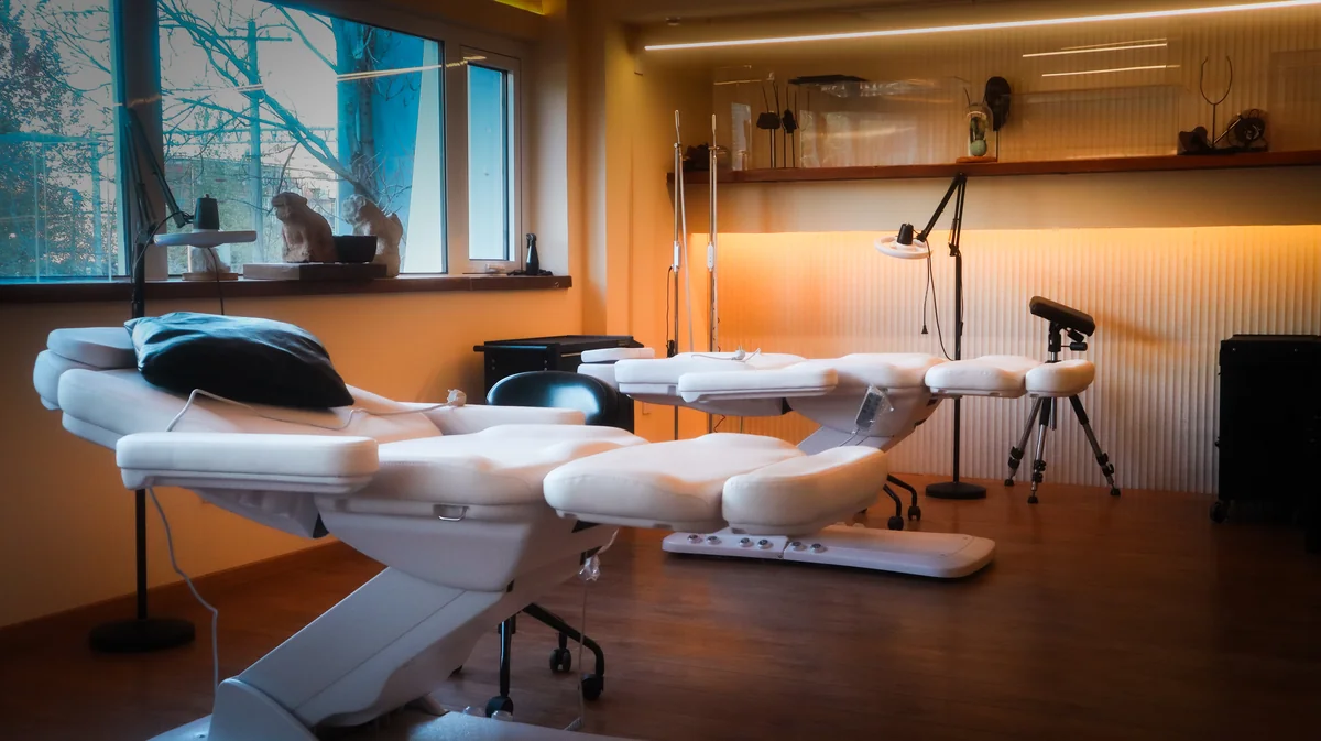 Professional tattoo workstations at Lei Shi Tattoo Beijing — clean modern studio with adjustable beds and professional lighting equipment